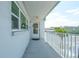 Balcony view with white railing, 'Exit' sign, and door adorned with wreath, inviting entry at 5356 81St N St # 26, St Petersburg, FL 33709