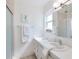 Bright bathroom featuring a clean white countertop, decorative seahorse art, and a shower with glass doors at 5356 81St N St # 26, St Petersburg, FL 33709