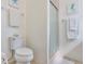 A clean bathroom featuring a toilet and a glass door shower decorated with seahorse themed art at 5356 81St N St # 26, St Petersburg, FL 33709