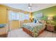 Cozy bedroom with colorful accents, featuring a queen-sized bed and bright yellow and green walls at 5356 81St N St # 26, St Petersburg, FL 33709