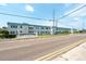 Paradise Shores condo complex featuring a welcoming sign, manicured landscaping, and a sunny day at 5356 81St N St # 26, St Petersburg, FL 33709