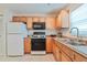 Bright kitchen features a gas range, microwave, and double stainless steel sink at 5356 81St N St # 26, St Petersburg, FL 33709