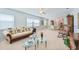 Bright living room featuring neutral walls, plush carpeting, ceiling fan, and dining area adjacent to kitchen at 5356 81St N St # 26, St Petersburg, FL 33709