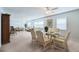 Spacious living room featuring a dining area with a modern ceiling fan and natural light from the windows at 5356 81St N St # 26, St Petersburg, FL 33709