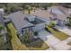 Well-maintained single-story home with a two-car garage, gray roof, and lush green lawn at 5538 Spanish Moss Cv, Bradenton, FL 34203
