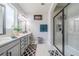 Modern bathroom with double vanity, framed mirror, and glass-enclosed shower at 5538 Spanish Moss Cv, Bradenton, FL 34203