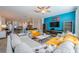 Bright, open living room features modern decor, wood floors, and seamlessly connects to the kitchen at 5538 Spanish Moss Cv, Bradenton, FL 34203