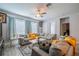 Bright living room featuring a large sectional sofa, modern coffee tables, and plenty of natural light at 5538 Spanish Moss Cv, Bradenton, FL 34203