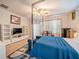 Well-lit main bedroom with a distinctive four-poster bed, seating area, and ample storage at 5538 Spanish Moss Cv, Bradenton, FL 34203
