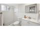 Clean, bright bathroom with white tile, modern fixtures, and updated vanity at 5620 Perkin Dr, New Port Richey, FL 34652