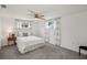 Light-filled bedroom features neutral walls, plush carpeting, and a comfortable bed with bright, natural lighting at 5620 Perkin Dr, New Port Richey, FL 34652