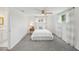 Cozy bedroom with plush gray carpet, complemented by a comfortable bed and bright, natural lighting at 5620 Perkin Dr, New Port Richey, FL 34652