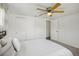 Comfortable bedroom featuring sliding door closets, neutral decor, and plush carpeting for a warm ambiance at 5620 Perkin Dr, New Port Richey, FL 34652
