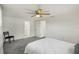 Well-lit bedroom boasts neutral walls, plush gray carpeting, with direct access to an en-suite bathroom at 5620 Perkin Dr, New Port Richey, FL 34652