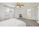 Bright bedroom features a ceiling fan, plush gray carpeting, and access to an en-suite bathroom at 5620 Perkin Dr, New Port Richey, FL 34652