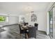 Dining area features a modern chandelier, stylish furniture, and beautiful gray floors at 5620 Perkin Dr, New Port Richey, FL 34652