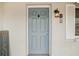 Close-up of the stylish front door with a welcome mat and decorative hardware at 5620 Perkin Dr, New Port Richey, FL 34652