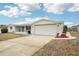 Home exterior showcasing a well-maintained lawn, wide driveway, and attached garage at 5620 Perkin Dr, New Port Richey, FL 34652