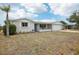 Well-maintained home with a manicured lawn, inviting front porch, and beautiful landscaping at 5620 Perkin Dr, New Port Richey, FL 34652