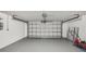 Clean and spacious garage with epoxy flooring, offering ample space for parking and storage at 5620 Perkin Dr, New Port Richey, FL 34652