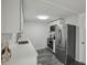 Modern kitchen with stainless steel appliances, white cabinetry, and sleek countertops at 5620 Perkin Dr, New Port Richey, FL 34652