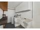 Bright laundry room with washer, dryer, sink, and storage cabinets at 5620 Perkin Dr, New Port Richey, FL 34652