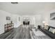 Bright, open-concept living and dining room with hardwood floors and neutral decor at 5620 Perkin Dr, New Port Richey, FL 34652