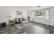 Bright living room features a modern sofa, stylish rug, and large window at 5620 Perkin Dr, New Port Richey, FL 34652