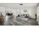 Open-concept living and dining room with hardwood floors and plenty of natural light at 5620 Perkin Dr, New Port Richey, FL 34652