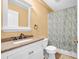 Cozy bathroom featuring a vanity and shower with patterned curtain at 5825 Meadowpark Pl, Lithia, FL 33547