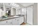 Bathroom features granite countertops, glass shower, and a spacious walk-in closet at 5825 Meadowpark Pl, Lithia, FL 33547