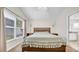 Bright bedroom featuring carpet, a window, and a wooden bed with neutral bedding at 5825 Meadowpark Pl, Lithia, FL 33547