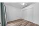 Bright bedroom featuring hardwood floors and a spacious closet at 5825 Meadowpark Pl, Lithia, FL 33547
