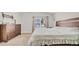 Bedroom includes carpet, a window, a dresser, and wall-mounted shelving at 5825 Meadowpark Pl, Lithia, FL 33547