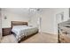 Bedroom with carpet, fan, and a glimpse into an adjoining bathroom space at 5825 Meadowpark Pl, Lithia, FL 33547