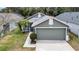Charming single-Gathering home showcasing a two-car garage and meticulously maintained landscaping at 5825 Meadowpark Pl, Lithia, FL 33547