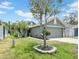 View of a one-story home with two car garage, showing the tree in the front yard and walkway at 5825 Meadowpark Pl, Lithia, FL 33547