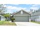 Charming one-story home with a two car garage, well-manicured lawn, and lush landscaping at 5825 Meadowpark Pl, Lithia, FL 33547