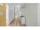 Hallway with light-colored walls and hardwood flooring at 5825 Meadowpark Pl, Lithia, FL 33547