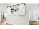 Stylish interior hallway featuring a white barn door at 5825 Meadowpark Pl, Lithia, FL 33547
