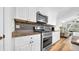 Well-equipped kitchen featuring stainless steel appliances, granite countertops, and ample cabinet space at 5825 Meadowpark Pl, Lithia, FL 33547