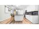 Modern kitchen island featuring granite countertops, breakfast bar, and stainless steel appliances in an open space at 5825 Meadowpark Pl, Lithia, FL 33547