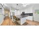 Eat-in kitchen island featuring granite countertops, pendant lighting, and modern appliances, perfect for casual dining at 5825 Meadowpark Pl, Lithia, FL 33547