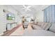 Open-concept floor plan featuring a living room, dining area, and kitchen with wood flooring and natural lighting at 5825 Meadowpark Pl, Lithia, FL 33547