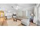 Living room, kitchen and eat-in kitchen in an open layout with wood floors and sliding door to the patio at 5825 Meadowpark Pl, Lithia, FL 33547