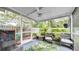 Screened porch includes outdoor seating and a beautiful backyard view at 5825 Meadowpark Pl, Lithia, FL 33547