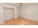 Bright bedroom with a ceiling fan, wood floors, and a closet with shelving for organization at 601 N Franklin St, Plant City, FL 33563