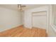 Bedroom boasting wood floors, a modern ceiling fan, and a well-lit closet at 601 N Franklin St, Plant City, FL 33563