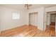 Bright bedroom featuring hardwood floors, a ceiling fan, and a closet with shelving at 601 N Franklin St, Plant City, FL 33563