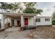 Charming single-story home featuring a covered carport, bright red front door and simple landscaping at 601 N Franklin St, Plant City, FL 33563